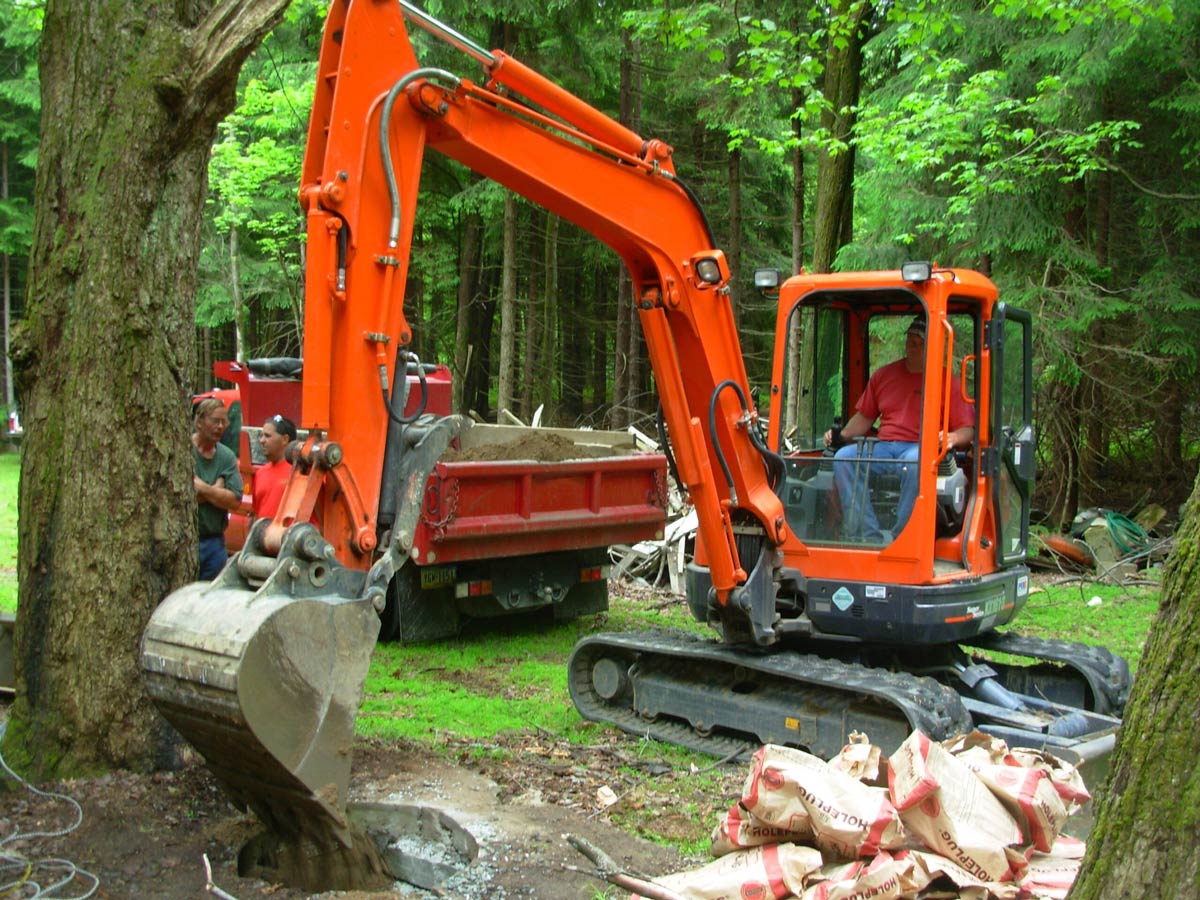 a professional team with an excavator, dump truck and a number of crew to execute the job