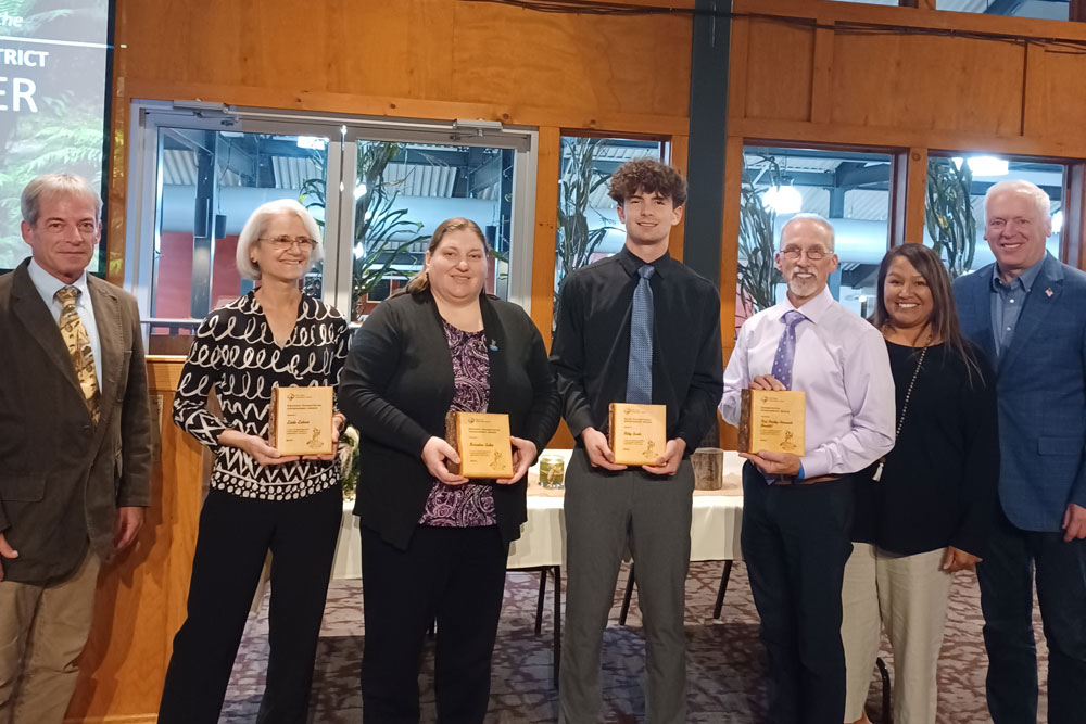 A group photo of the 2024 Conservation Achievement Award recipients holding their plaques