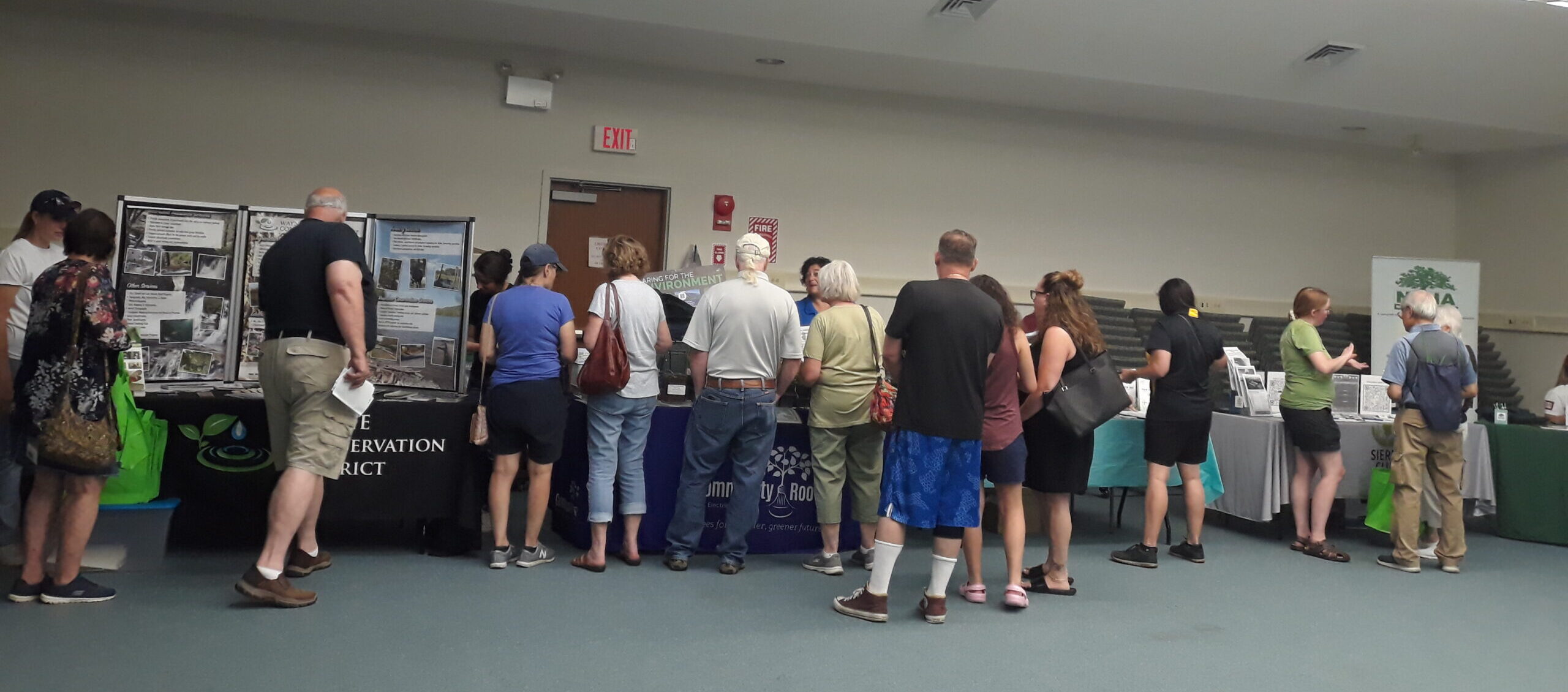 People stand talking at display tables