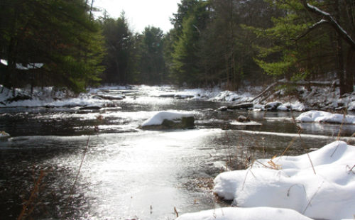 Photo of Blooming Grove Creek in winter in Pike County, PA. Download the DEP guide to stream work in your community.