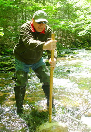 Photo of spring water quality data gathering in a Pike County, PA creek.