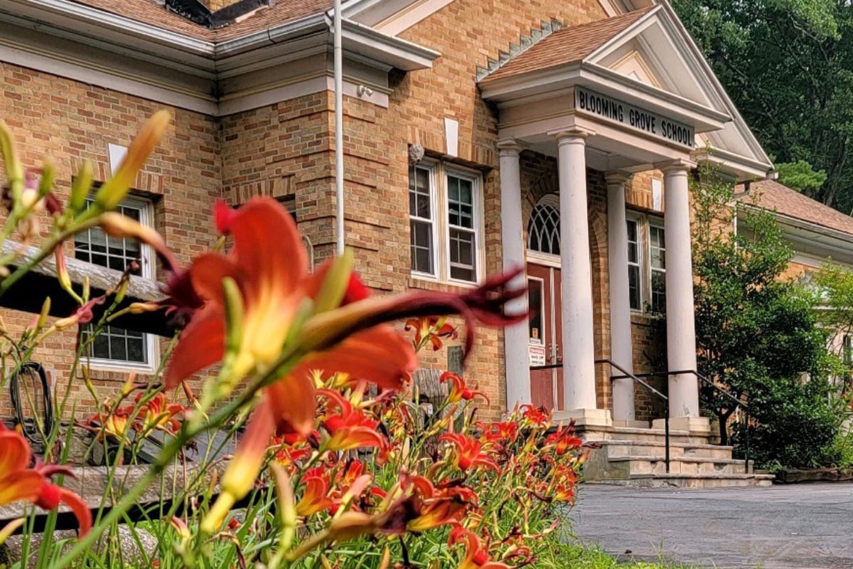 The front of the District building with orange lilies in front