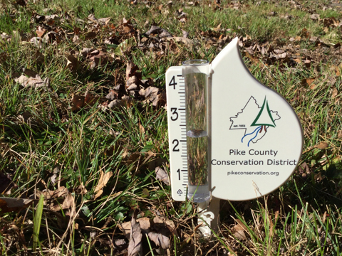 A backyard rain gauge from Pike County Conservation District with the PCCD logo inside a raindrop