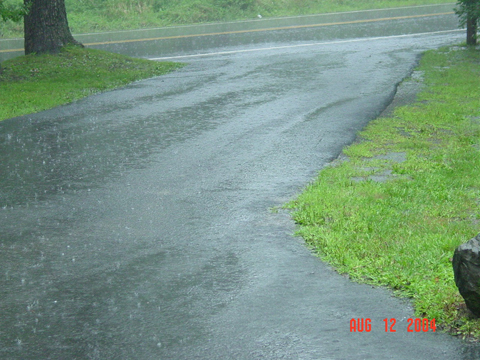Rainwater runoff on a Pike County, PA impervious surface driveway. Proactive measures can help manage stormwater.