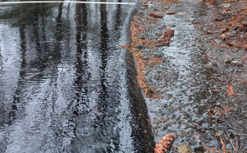 Rain water running over a paved parking lot