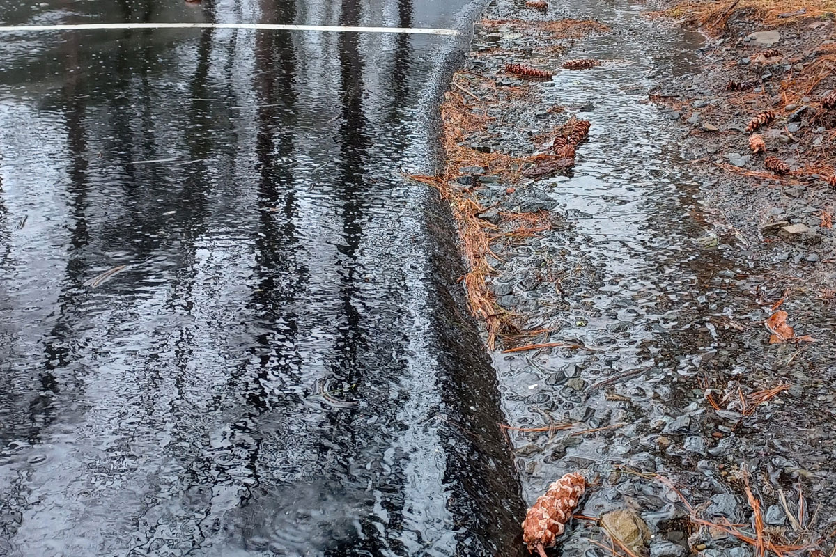 Rain water running over a paved parking lot