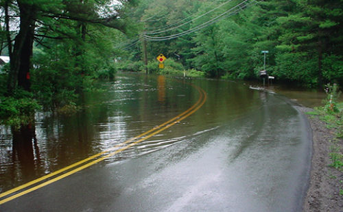 A paved road with stormwater flooding in Pike County, PA.