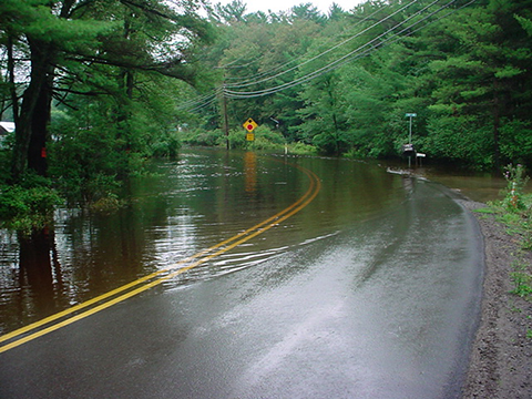 A paved road with stormwater flooding in Pike County, PA.