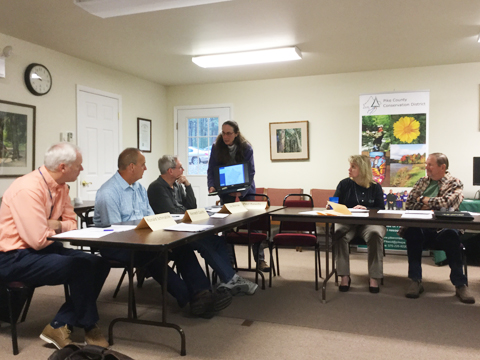 Photo of USGS Hydrologisy Lisa Senior presenting groundwater level final report to the Pike County Conservation District Board, seated at a table.