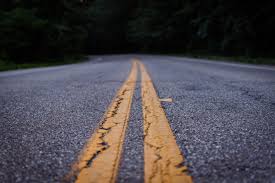 A closeup of the double yellow lines on a paved road