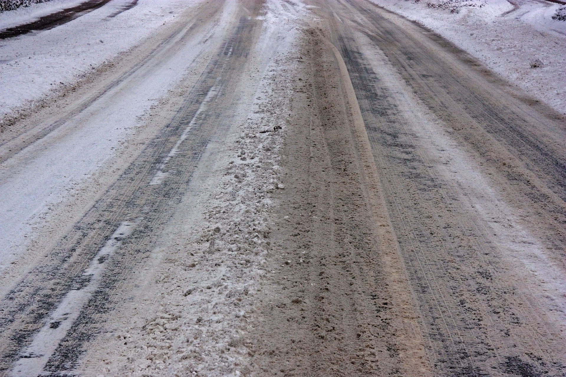 Closeup of a road with snow and salt