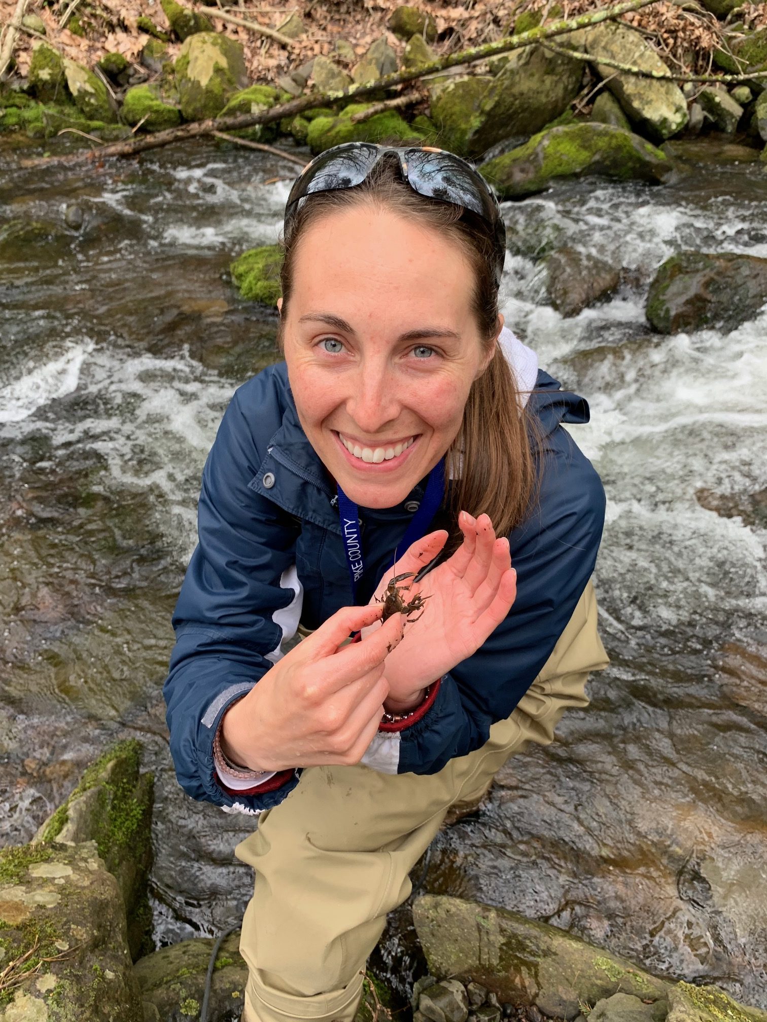 Watershed specialist Rachel Posavetz, showing off a macroinvertebrate in a Pike County Stream
