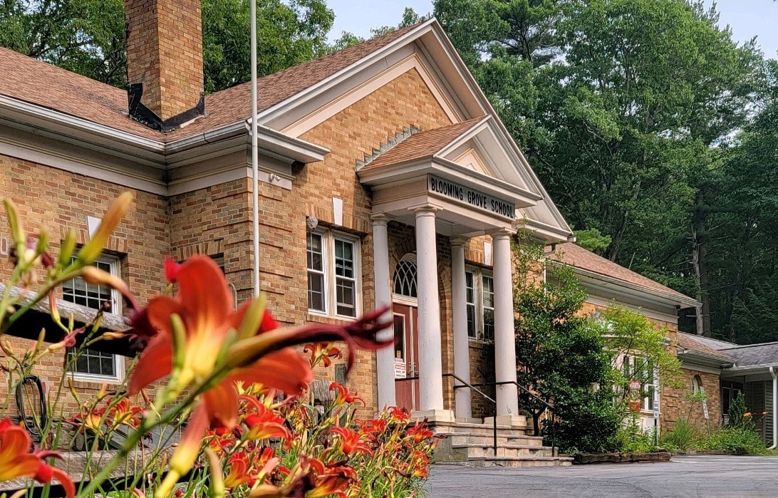 The PCCD building in spring with lilies